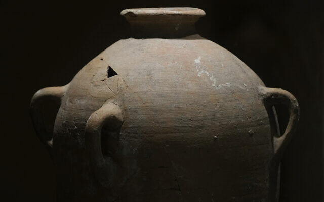 A rare bronze-era jar, newly reassembled, returned to public exhibition after a four-year-old accidentally broke the jar in August during a visit in Hecht Museum of the University of Haifa, September 11, 2024. (AP Photo/Mahmoud Illean)