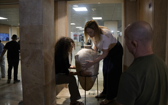 A rare Bronze Era jar, newly reassembled, returned to public exhibition after a four-year-old accidentally broke it in August during a visit to the Hecht Museum in Haifa, on September 11, 2024. (AP Photo/Mahmoud Illean)
