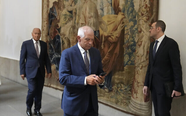 European Union foreign policy chief Josep Borrell looks at his phone as he makes his way to a meeting with members of the Arab-Islamic Contact Group for Gaza and representatives of different European foreign ministries in Madrid, Spain, September 13, 2024. (AP Photo/Paul White)