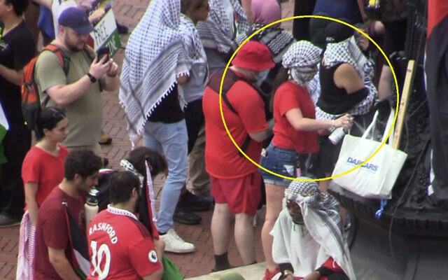 This image from United States Park Police video in an affidavit in support of an application for an arrest warrant for Isabella Giordano shows Giordano, circled in yellow, on July 24, 2024, in Washington, spray painting the base of a flagpole in Columbus Circle during a protest against Prime Minister Benjamin Netanyahu's address to Congress. (USPP via AP) This image from United States Park Police video in an affidavit in support of an application for an arrest warrant for Isabella Giordano shows Giordano, circled in yellow, on July 24, 2024, in Washington, spray painting the base of a flagpole in Columbus Circle during a protest against Prime Minister Benjamin Netanyahu's address to Congress. (USPP via AP)