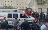 People gather outside the American University hospital after the arrival of several men who were wounded by exploded handheld pagers, in Beirut, Lebanon, Sept. 17, 2024, after an attack, blamed on Israel, targeting Hezbollah terrorists. (AP Photo/Bassam Masri)