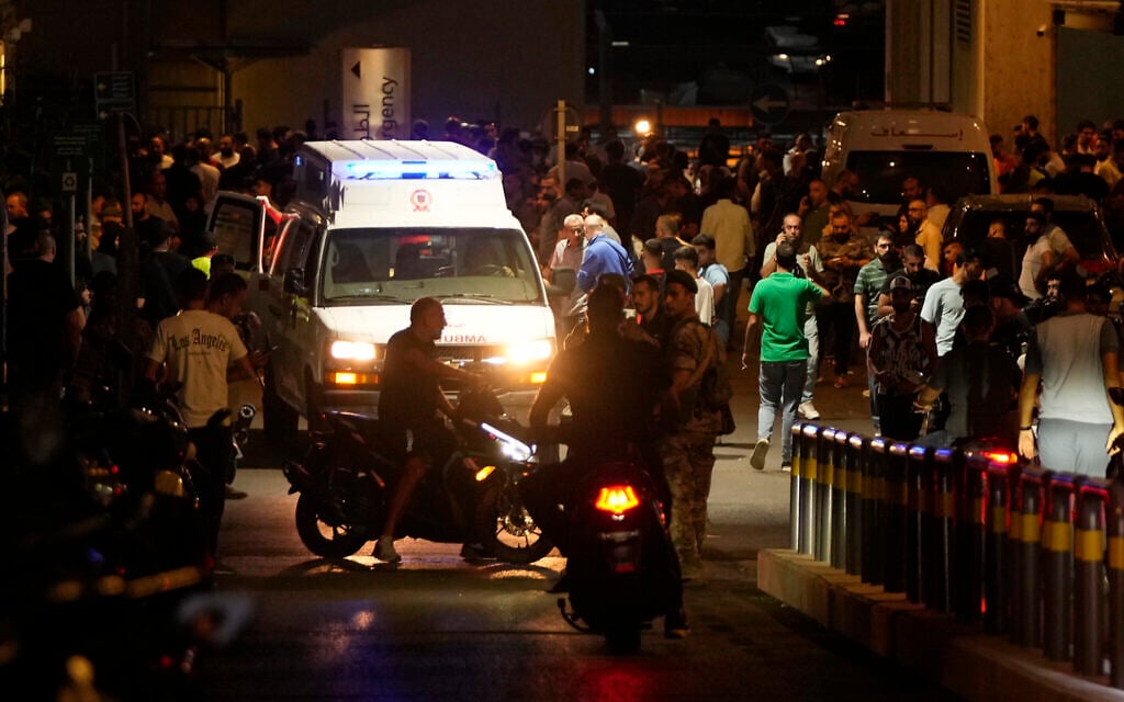 People gather around an ambulance carrying wounded people whose handheld pager exploded, at the emergency entrance of the American University hospital in Beirut, Lebanon, September 17, 2024, after an attack, blamed on Israel, targeting Hezbollah fighters. (AP Photo/Hassan Ammar)