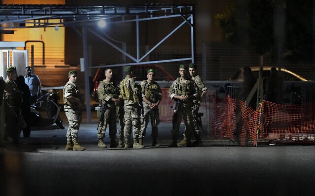 Lebanese soldiers stand guard, as their comrades prepare to detonate a walkie-talkie that was found at the parking of the American University Hospital, in Beirut, Lebanon, on September 18, 2024. Hezbollah communications devices exploded for a second day, in attacks blamed on Israel. Israel has not commented. (AP Photo/Hassan Ammar) Lebanese soldiers stand guard, as their comrades prepare to detonate a walkie-talkie that was found at the parking of the American University Hospital, in Beirut, Lebanon, on September 18, 2024. Hezbollah communications devices exploded for a second day, in attacks blamed on Israel. Israel has not commented. (AP Photo/Hassan Ammar)