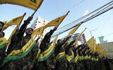 Hezbollah members march during a funeral procession in the southern suburb of Beirut, September 21, 2024. (AP Photo/Bilal Hussein)