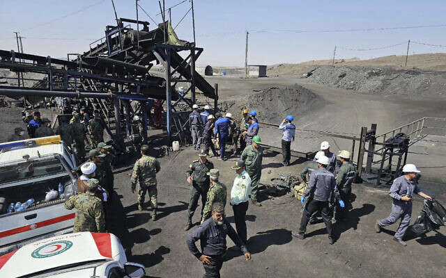 In this photo released by Iranian Red Crescent Society, rescue personnel, police officers and some other people gather around the site of a coal mine where methane leak sparked an explosion on Saturday, in Tabas, some 335 miles (540 kilometers) southeast of the capital Tehran, Iran, Sept. 22, 2024. (Iranian Red Crescent Society, via AP) In this photo released by Iranian Red Crescent Society, rescue personnel, police officers and some other people gather around the site of a coal mine where methane leak sparked an explosion on Saturday, in Tabas, some 335 miles (540 kilometers) southeast of the capital Tehran, Iran, Sept. 22, 2024. (Iranian Red Crescent Society, via AP)