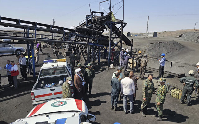 In this photo released by Iranian Red Crescent Society, rescue personnel, police officers and some other people gather around the site of a coal mine where methane leak sparked an explosion on Saturday, in Tabas, some 335 miles (540 kilometers) southeast of the capital Tehran, Iran, Sunday, Sept. 22, 2024. (Iranian Red Crescent Society, via AP) In this photo released by Iranian Red Crescent Society, rescue personnel, police officers and some other people gather around the site of a coal mine where methane leak sparked an explosion on Saturday, in Tabas, some 335 miles (540 kilometers) southeast of the capital Tehran, Iran, Sunday, Sept. 22, 2024. (Iranian Red Crescent Society, via AP)