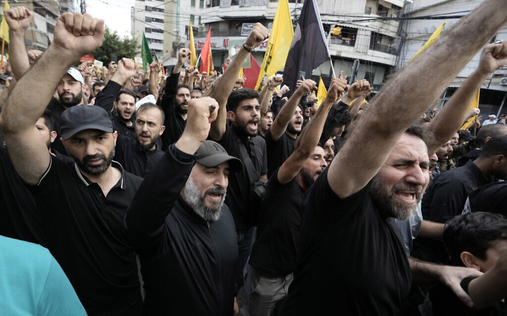 Hezbollah supporters shout slogans during the funeral procession of Hezbollah commander Ibrahim Akil and operative Mahmoud Hamad in Beirut's southern suburb, September 22, 2024. (AP/Bilal Hussein)
