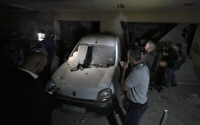Journalists are given a tour at the site of an Israeli airstrike in Beirut's southern suburbs, September 23, 2024. (AP Photo/Bilal Hussein)