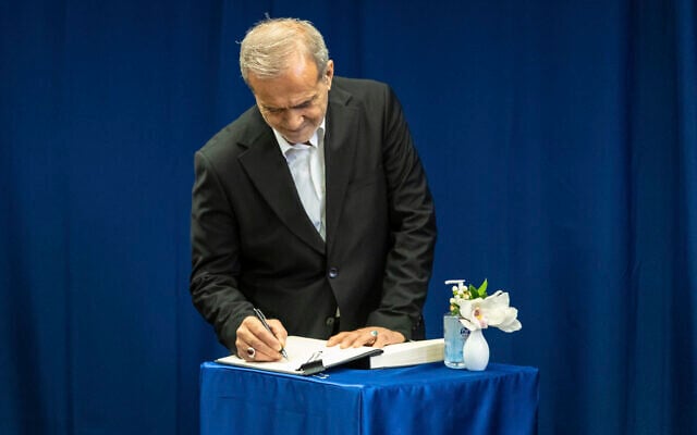 President of Iran Masoud Pezeshkian signs a guest book at the United Nations headquarters in New York, Monday, Sept. 23, 2024. (AP Photo/Stefan Jeremiah)