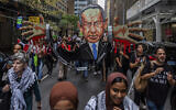 Anti-Israel, pro-Palestinian demonstrators march with a cutout depicting Prime Minister Benjamin Netanyahu near the United Nations headquarters, September 26, 2024, in New York. (AP Photo/Julia Demaree Nikhinson)