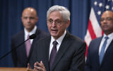 Attorney General Merrick Garland, flanked by Matt Graves, U.S. attorney for the District of Columbia, left, and Ronald Davis, director of the United States Marshals Service, holds a news conference as the Justice Department announced criminal charges against Iranian operatives suspected of hacking Donald Trump's presidential campaign and disseminating stolen information to media organizations, at the Justice Department in Washington, Friday, Sept. 27, 2024. (AP Photo/J. Scott Applewhite)