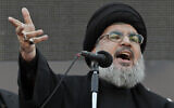 Hezbollah leader Sheik Hassan Nasrallah, speaks to the crowd in a rare public appearance during Ashura, that marks the death of Shiite Islam's Imam Hussein, in the suburbs of Beirut, Thursday, Nov. 14, 2013. (AP Photo/Bilal Hussein, File)