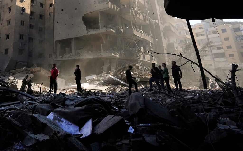 Illustrative: People check the site of the assassination of Hezbollah terror group leader Hassan Nasrallah in Beirut's southern suburbs, Sept. 29, 2024. (AP/Hassan Ammar)
