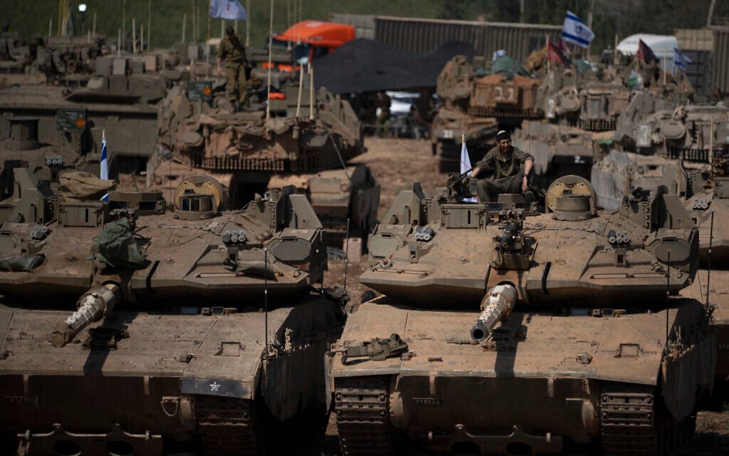 An Israeli soldier sits on the top of a tank, in northern Israel, September 30, 2024. (AP Photo/Leo Correa)