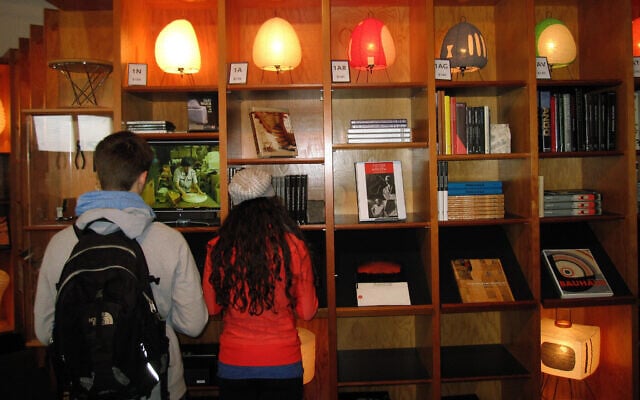 In this illustrative photo from April 2013, lamps designed by the late sculptor Isamu Noguchi are displayed on shelves at the gift shop of the Noguchi Museum in Long Island City, New York. (AP Photo/Beth J. Harpaz)
