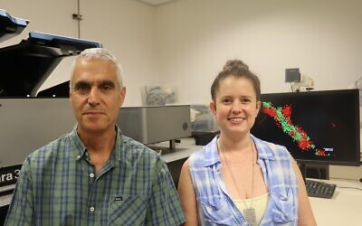Prof. Uri Ashery, Tel Aviv University, left, stands with Ph.D. student Ofir Sade in front of the super-resolution microscope. (Courtesy, Tel Aviv University)