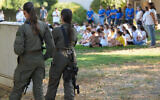 Israeli soldiers on guard while students arrive to their first day of school at Lev Ha'Emek School in Neot Mordechai, northern Israel, on Septmber 1, 2024.(Ayal Margolin/Flash90)