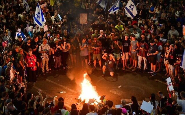 Protesters light bonfires on the street during a rally calling for the release of the hostages held by Hamas in Gaza, outside the Defense Ministry Headquarters in Tel Aviv, September 3, 2024. (Avshalom Sassoni/Flash90) Protesters light bonfires on the street during a rally calling for the release of the hostages held by Hamas in Gaza, outside the Defense Ministry Headquarters in Tel Aviv, September 3, 2024. (Avshalom Sassoni/Flash90)