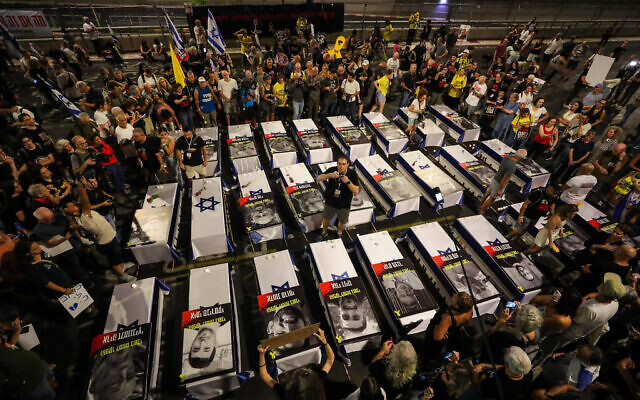 Israelis demonstrate around 27 coffins symbolizing hostages killed in Gaza, as they protest for the release of Israelis held by Hamas terrorists in Gaza, outside the Defense Ministry Headquarters in Tel Aviv, September 5, 2024. (Jamal Awad / Flash90)