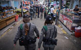 Border police officers walk through the market in Ramle a day after a nearby explosion killed four and injured nine others, September 13, 2024. (Avshalom Sassoni/Flash90)