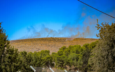 Smoke rises from a fire sparked by rockets fired from Lebanon outside Kibbutz Amiad, in northern Israel, September 14, 2024. (Michael Giladi/Flash90)
