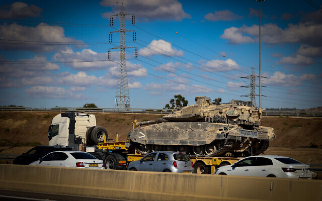An IDF tank seen on top of a truck in traffic, on their way to the northern border with Lebanon, September 18, 2024. (Yossi Aloni/Flash90)