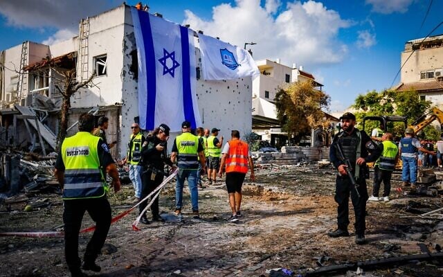 Israeli rescue workers at the site where a missile fired from Lebanon hit houses and cars in Kiryat Bialik, northern Israel, September 22, 2024. (Chaim Goldberg/Flash90)
