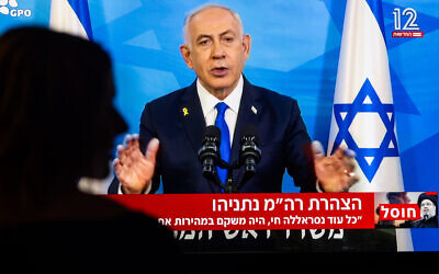 A woman watches a press conference of Israeli Prime Minister Benjamin Netanyahu at her home in Jerusalem, September 28, 2024. (Yonatan Sindel/Flash90)
