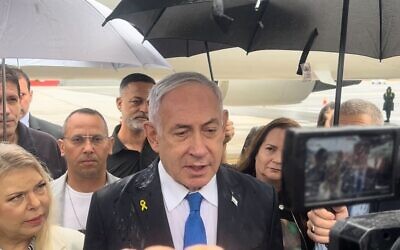 Prime Minister Benjamin Netanyahu addresses the press from the tarmac after landing in New York, September 26, 2024. (Lazar Berman/Times of Israel)