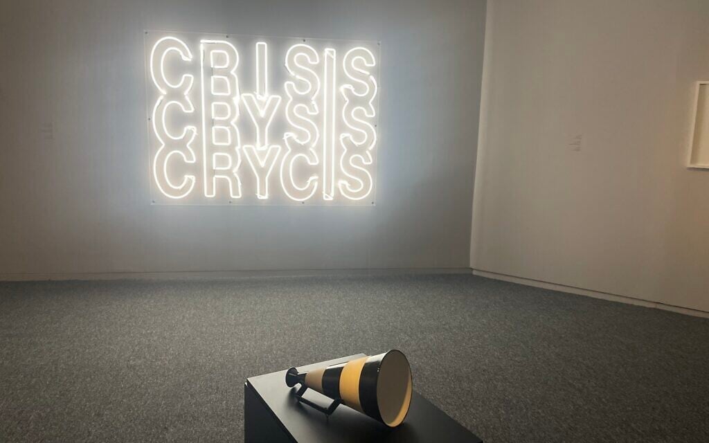 Yael Bartana's 'CRISIS-CRYSIS-CRYCIS,' 2020, Neon, and Guy Zagursky's 'No Lifeguard on Duty (Black Flag),' 2024, Ceramics at the 'I Don't Want to Forget' exhibit at Tel Aviv Museum of Art, opening September 2024 (Jessica Steinberg/Times of Israel) Yael Bartana's 'CRISIS-CRYSIS-CRYCIS,' 2020, Neon, and Guy Zagursky's 'No Lifeguard on Duty (Black Flag),' 2024, Ceramics at the 'I Don't Want to Forget' exhibit at Tel Aviv Museum of Art, opening September 2024 (Jessica Steinberg/Times of Israel)