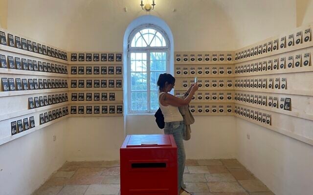 Visitors visit the exhibit 'Hope / The End' by Unga and Broken Fingaz at Jerusalem Design Week, September 19-26, 2024 (Jessica Steinberg/Times of Israel)