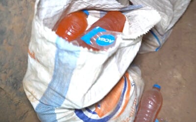 This image, a screenshot from a video released by the IDF on September 10, 2024, shows bottles filled with urine and a makeshift toilet inside of a tunnel in southern Gaza's Rafah where six Israeli hostages were murdered by Hamas terrorists (Israel Defense Forces)