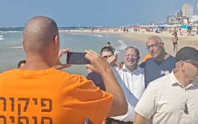 National Security Minister Itamar Ben Gvir being photographed with beachgoers in Tel Aviv, September 6, 2024. (X screenshot)