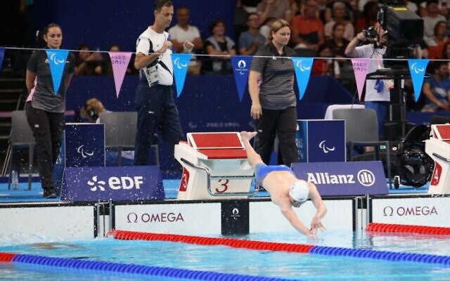 Israeli swimmer Ariel Malyar dives into the water at the start of the men's 50m freestyle S4 at the 2024 Paris Paralympics on September 6, 2024. (Keren Isaacson)