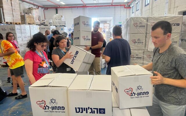 A group of Camp Ramah/Birthright participants help pack food supplies in Israel, September 2024. The trip was for adults with non-physical disabilities who volunteered in various locations around Israel. (courtesy Howard Blas)
