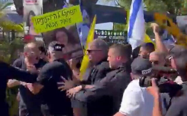 Education Minister Yoav Kisch escorted by police as protesters demanding a hostage deal rally at the HaElla school in Kfar Menachem, southern Israel, September 4, 2024. (X screenshot: used in accordance with Clause 27a of the Copyright Law) Education Minister Yoav Kisch escorted by police as protesters demanding a hostage deal rally at the HaElla school in Kfar Menachem, southern Israel, September 4, 2024. (X screenshot: used in accordance with Clause 27a of the Copyright Law)