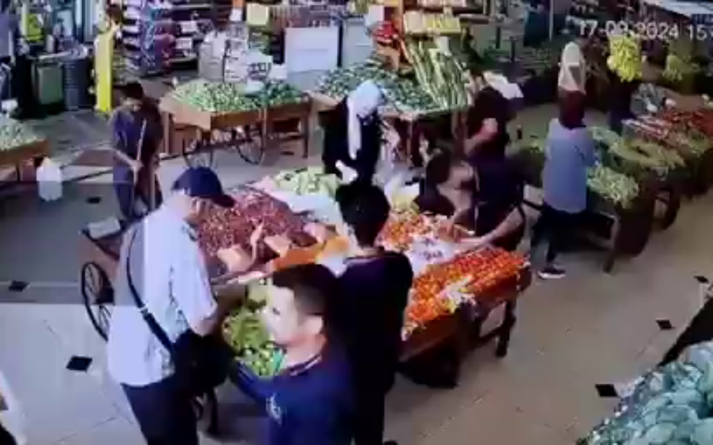 A video shows a man, left, just before he was injured by an explosion in a market in Beirut on September 17, 2024, as pagers used by Hezbollah exploded across Lebanon. (Screen capture: X)