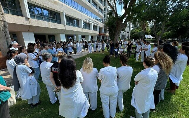 Workers at the Loewenstein Rehabilitation Medical Center in Raanana gather in memory of murdered hostage Carmel Gat, September 1, 2024 (Courtesy) Workers at the Loewenstein Rehabilitation Medical Center in Raanana gather in memory of murdered hostage Carmel Gat, September 1, 2024 (Courtesy)