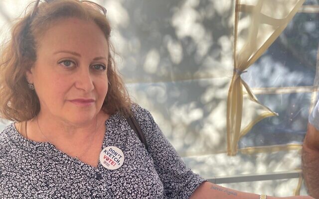 Suzan Lopatin shows her 'Never Again' tattoo before canvassing for Vice President Kamala Harris in suburban Philadelphia, Pennsylvania, October 20, 2024. (Ron Kampeas/JTA)