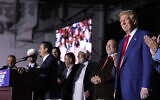 Republican presidential nominee former US President Donald Trump, right, looks on as local Muslim leaders speak during a campaign rally at the Suburban Collection Showplace, October 26, 2024, in Novi, Michigan (AP Photo/Alex Brandon)