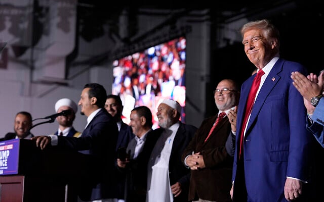Republican presidential nominee former US President Donald Trump, right, looks on as local Muslim leaders speak during a campaign rally at the Suburban Collection Showplace, October 26, 2024, in Novi, Michigan (AP Photo/Alex Brandon) Republican presidential nominee former US President Donald Trump, right, looks on as local Muslim leaders speak during a campaign rally at the Suburban Collection Showplace, October 26, 2024, in Novi, Michigan (AP Photo/Alex Brandon)