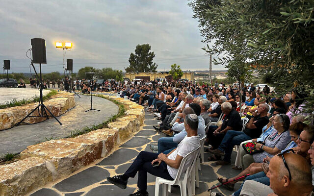 A ceremony at Netiv Ha'asara on October 6, 2024, commemorating the 20 residents who were slain by Hamas on October 7, 2023 (Shalom Yerushalmi / Times of Israel)