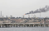 A picture taken on March 12, 2017, shows an oil facility in the Khark Island, Iran, on the shore of the Gulf. (Atta Kenare/ AFP)