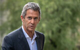 French-Israeli diamond magnate Beny Steinmetz looks on as he arrives for the third day of his appeal against a corruption sentence linked to mining rights in Guinea, at the Geneva's courthouse, on August 31, 2022. (Fabrice COFFRINI / AFP)