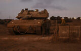 Israeli soldiers gather near a tank in the Golan Heights on September 19, 2024. (Jalaa MAREY / AFP)