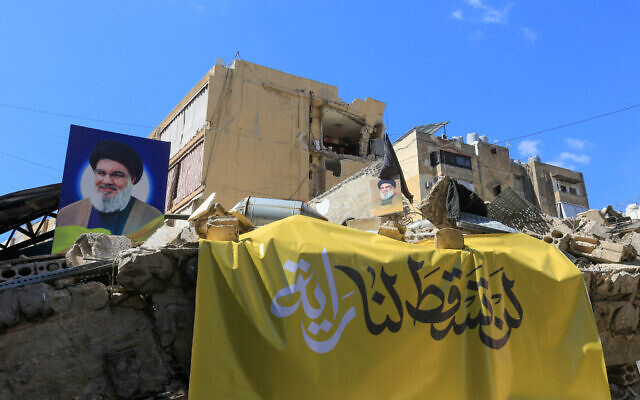 A picture taken during a tour organized by Hezbollah's media office on October 2, 2024, shows portraits of the Lebanese terror group's slain leader Hassan Nasrallah hanging on the rubble of a building destroyed by an Israeli airstrike in Beirut's southern suburbs. (AFP) A picture taken during a tour organized by Hezbollah's media office on October 2, 2024, shows portraits of the Lebanese terror group's slain leader Hassan Nasrallah hanging on the rubble of a building destroyed by an Israeli airstrike in Beirut's southern suburbs. (AFP)