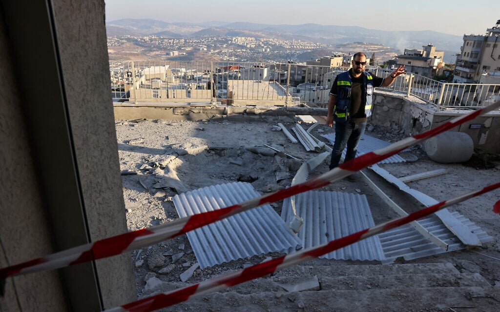 A man inspects the damage at a house hit during a rocket attack from southern Lebanon that targeted the northern Arab-Israeli village of Deir al-Asad on October 5, 2024. (Photo by AHMAD GHARABLI / AFP)