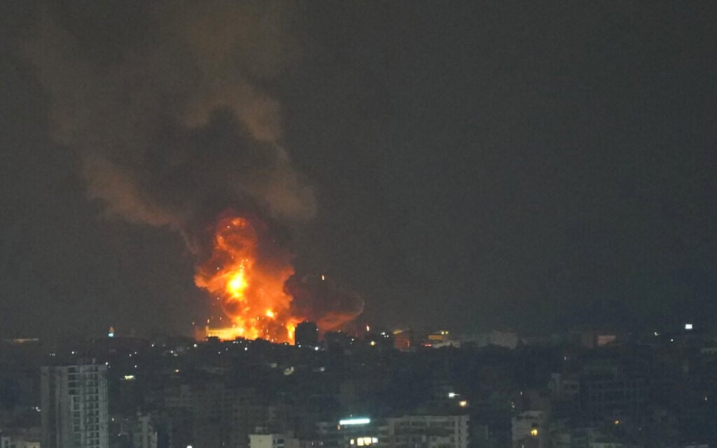 Fire and smoke rise at an area targeted by an Israeli airstrike on Beirut's southern suburb on October 6, 2024. (Photo by ETIENNE TORBEY / AFP)