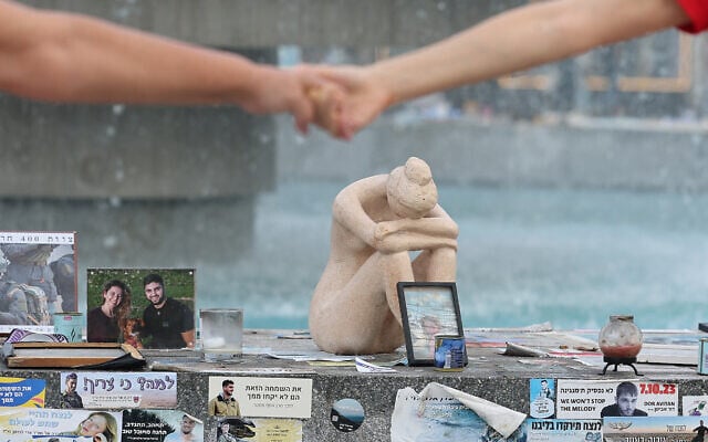 People hold hands at a memorial event marking the first anniversary of Hamas's October 7 terror onslaught, at Tel Aviv's Dizengoff Square, October 7, 2024. (Jack Guez / AFP) People hold hands at a memorial event marking the first anniversary of Hamas's October 7 terror onslaught, at Tel Aviv's Dizengoff Square, October 7, 2024. (Jack Guez / AFP)