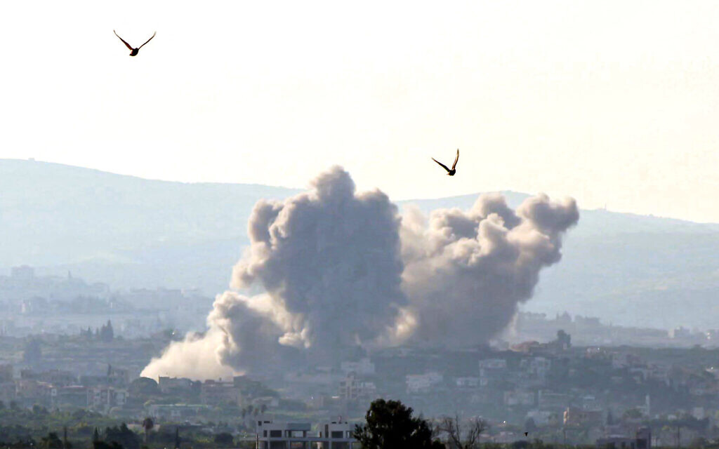 Illustrative: Birds fly away as a smoke cloud erupts following an Israeli airstrike on a village near Lebanon's southern city of Tyre on October 9, 2024. (Kawnat HAJU / AFP)